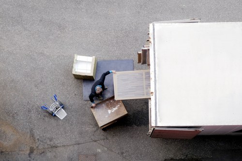 Mover securing packed boxes inside a removal van
