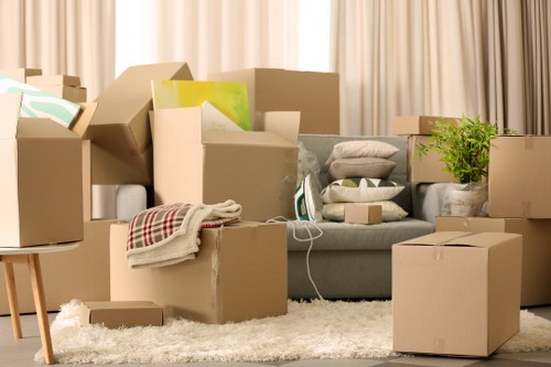 Professional movers carrying furniture through a Hampstead home