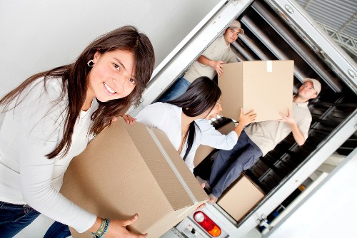 Removal team handling furniture in a Hampstead property