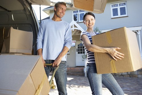 Movers handling furniture carefully on a narrow Hampstead stairway