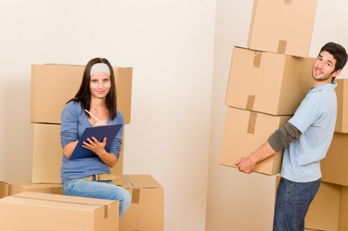 Moving team handling boxes and furniture near Hampstead